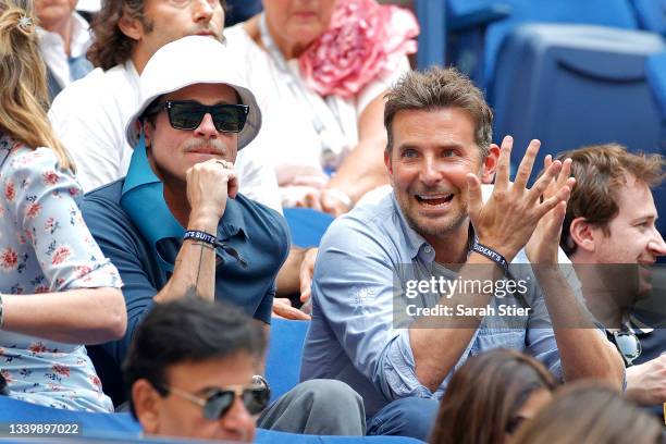 Actors Brad Pitt and Bradley Cooper watch the Men's Singles final match between Daniil Medvedev of Russia and Novak Djokovic of Serbia on Day...