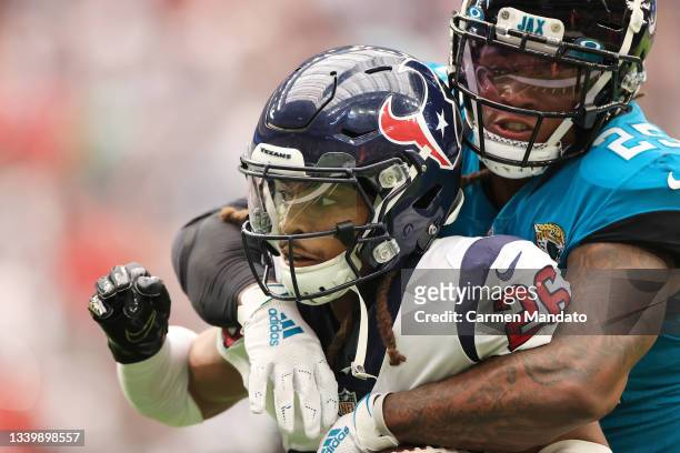 Vernon Hargreaves III of the Houston Texans is wrapped up by James Robinson of the Jacksonville Jaguars during the game at NRG Stadium on September...