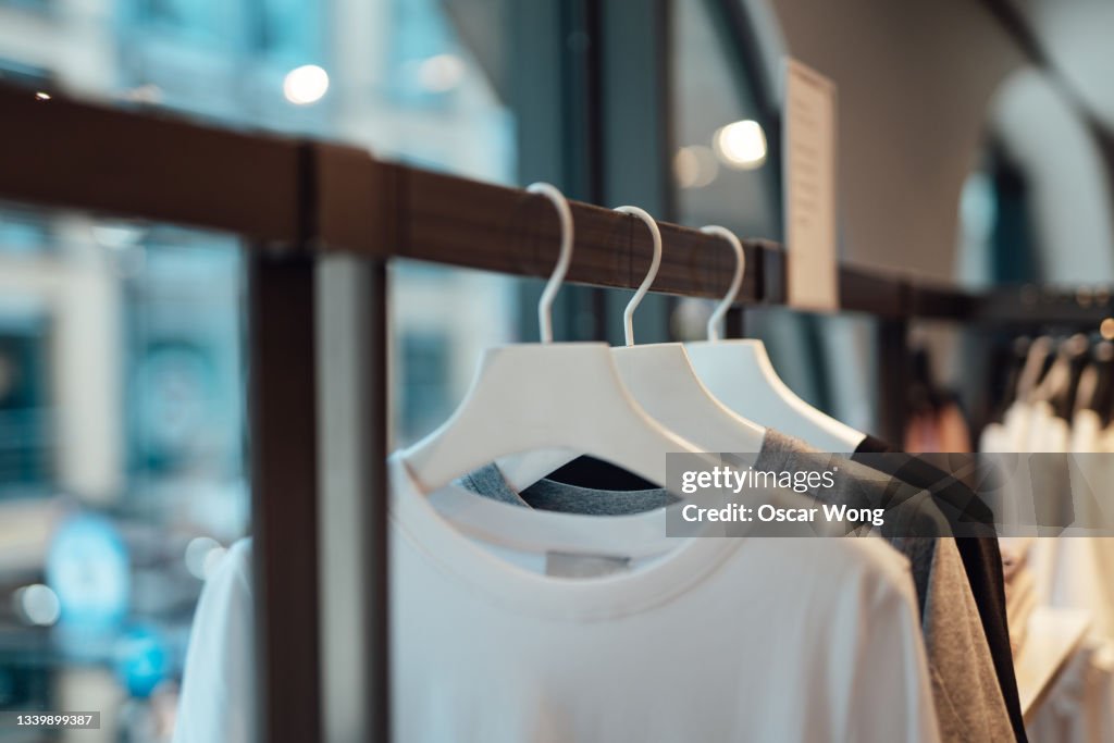 Clothes hanging on rack in fashion store