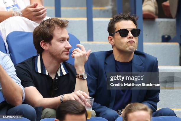 Actors Joseph Mazzello and Rami Malek watch the Men's Singles final match between Daniil Medvedev of Russia and Novak Djokovic of Serbia on Day...