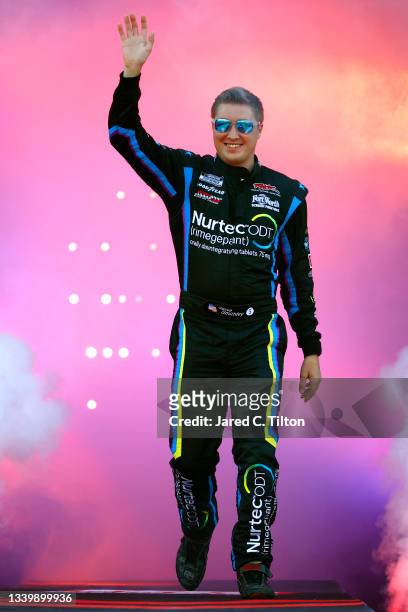 Garrett Smithley, driver of the 9/11 Scheme Chevrolet, waves to fans during pre-race ceremonies prior to the NASCAR Cup Series Federated Auto Parts...