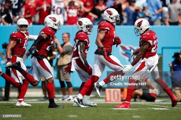 Isaiah Simmons of the Arizona Cardinals celebrates with teammates after his interception against the Tennessee Titans during the third quarter at...