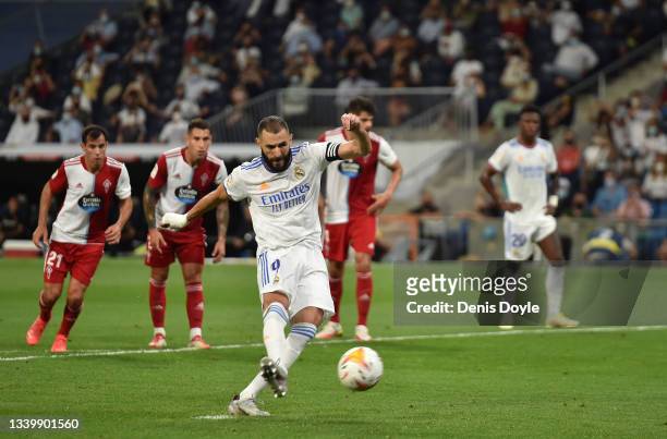 Karim Benzema of Real Madrid scores their team's 5th goal from the penalty spot during the La Liga Santander match between Real Madrid CF and RC...