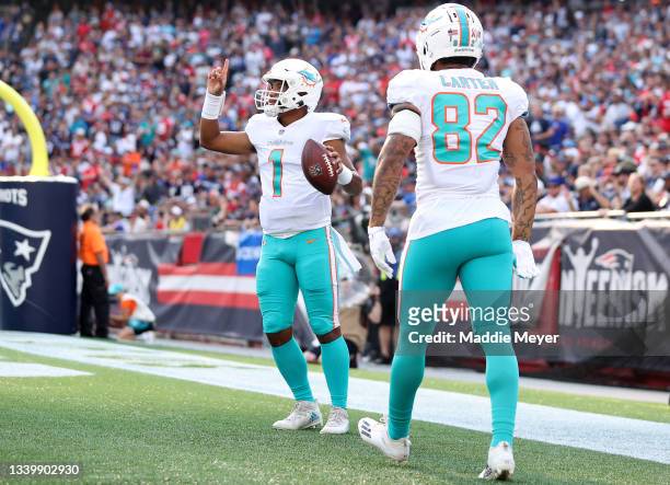 Tua Tagovailoa of the Miami Dolphins celebrates after rushing for a three yard touchdown during the first quarter against the New England Patriots at...