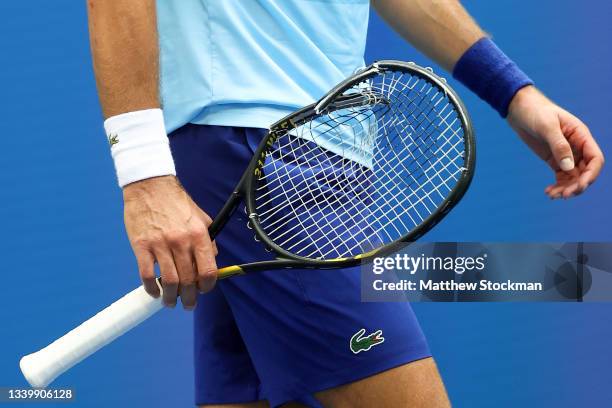 Detailed view is seen as Novak Djokovic of Serbia holds his broken racket as he plays against Daniil Medvedev of Russia during their Men's Singles...