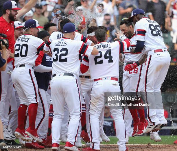Leury Garcia of the Chicago White Sox is mobbed by teammates as he comes to the plate after hitting a walk-off, solo home run in the 9th inning...
