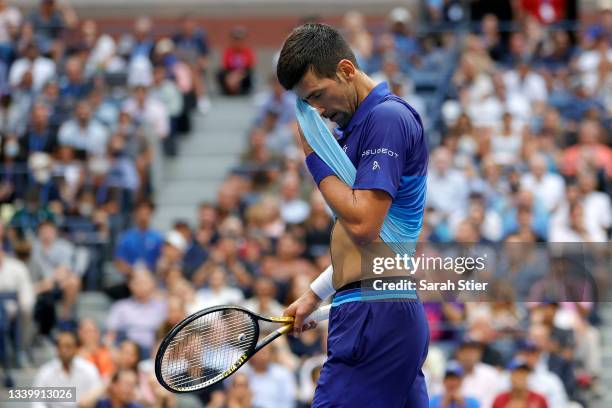 Novak Djokovic of Serbia dries his face as he plays against Daniil Medvedev of Russia during their Men's Singles final match on Day Fourteen of the...