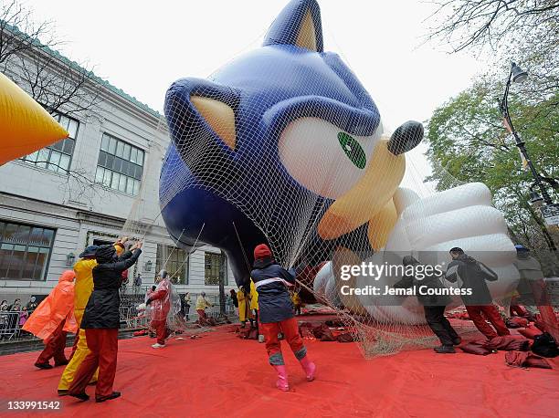 Float handlers secure a Sonic the Hedgehog float during the 85th annual Macy's Thanksgiving Day Parade Inflation Eve event on November 23, 2011 in...