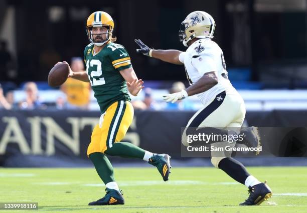 Aaron Rodgers of the Green Bay Packers looks to pass against Cameron Jordan of the New Orleans Saints during the first half at TIAA Bank Field on...