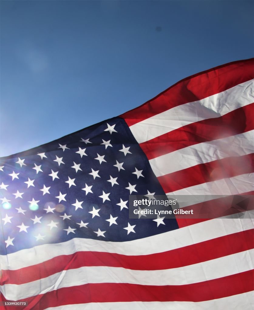 American flags fly with a beautiful bright blue sky in Malibu, CA
