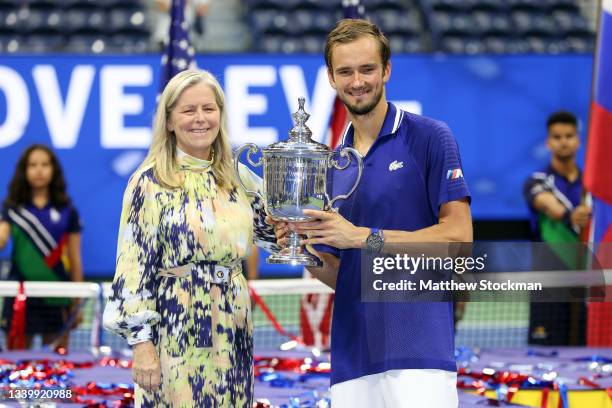 Daniil Medvedev of Russia celebrates with the championship trophy alongside Stacey Allaster, USTA Executive Chief, after defeating Novak Djokovic of...