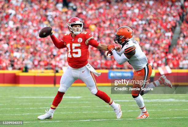 Quarterback Patrick Mahomes of the Kansas City Chiefs scrambles as middle linebacker Anthony Walker of the Cleveland Browns chases during the game at...