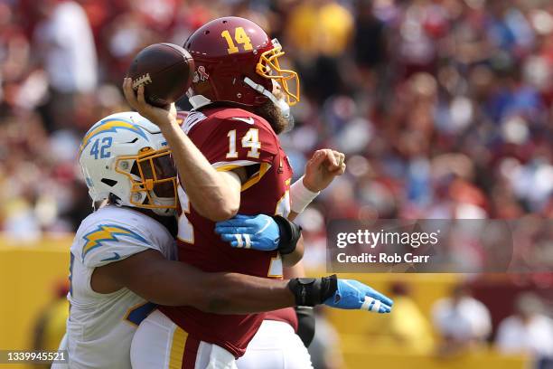 Linebacker Uchenna Nwosu of the Los Angeles Chargers hits quarterback Ryan Fitzpatrick of the Washington Football Team in the second quarter at...