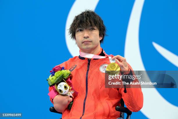 Gold medalist Takayuki Suzuki of Team Japan celebrates on the podium at the medal ceremony for the Swimming Men's 100m Freestyle - S4 on day 2 of the...