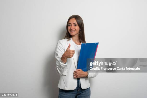 business woman holding clipboard and showing ok sign - carta documento stock pictures, royalty-free photos & images