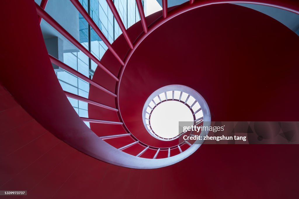 Close-up View Of Red spiral staircase.