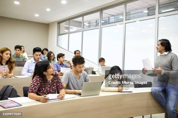 professor teaching university students in classroom - professor stock-fotos und bilder