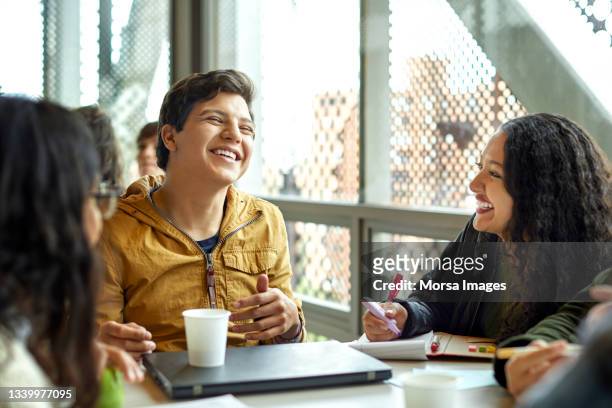 happy students discussing in cafeteria - 19 to 22 years and friends and talking stock pictures, royalty-free photos & images