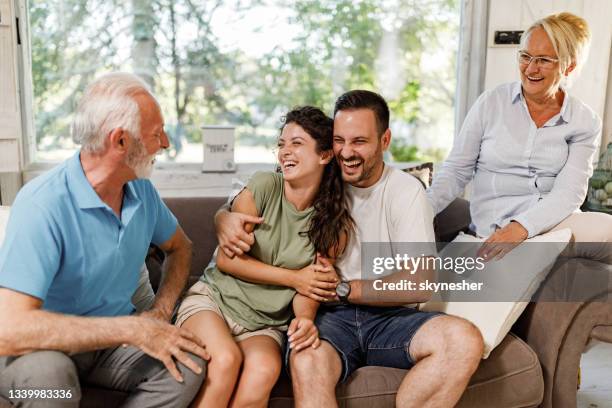 happy couple talking to mature couple at home. - father in law stock pictures, royalty-free photos & images