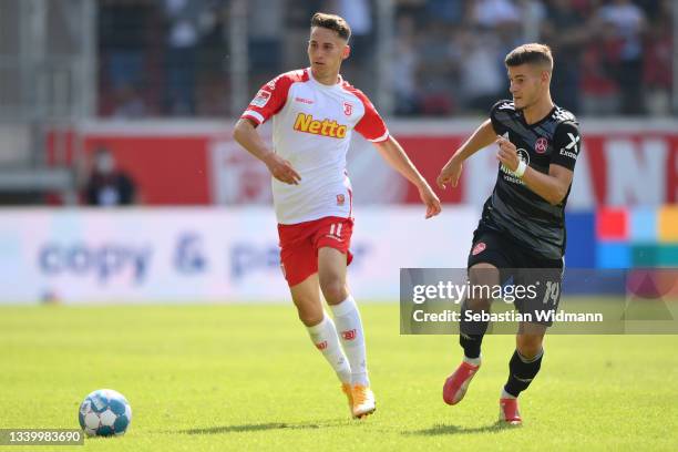 Kondrad Faber of SSV Jahn Regensburg and Tom Krauss of 1.FC Nuernberg compete for the ball during the Second Bundesliga match between SSV Jahn...