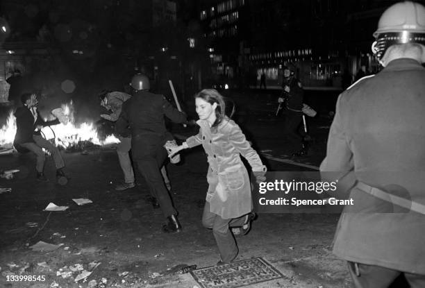 During an anti-war demonstration in Harvard Square, a policeman chases a protestor while a second protestor flees, Cambridge, Massachussetts, April...