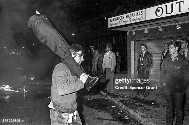 During an anti-war demonstration in Harvard Square, a demonstrator carries the legs for a store window dummy, April 1970.