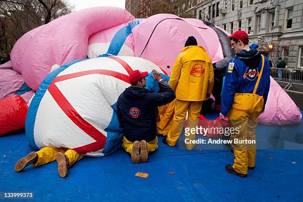 Volunteers help inflate the Energizer Bunny flotation for the Macy's Thanksgiving Day Parade on November 23, 2011 on West 77th Street in New York...