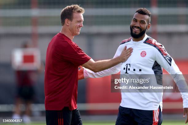 Julian Nagelsmann, head coach of FC Bayern München shake hands with his player Eric Maxim Choupo-Moting during a FC Bayern training session at...