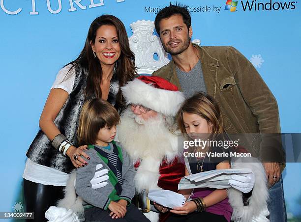 Actress Brooke Burke Charvet, Husband David Charvet and their two children Shaya Charvet and Rain Charvet pose with Santa Claus at "Brooke Burke...