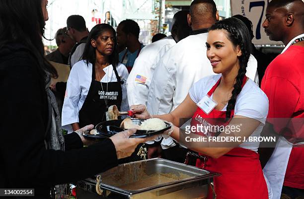 Socialite Kim Kardashian serves the homeless and those less fortunate for a lunchtime meal at the Los Angeles Mission on November 23, 2011 in...