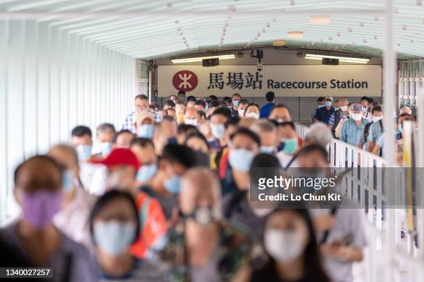 Racegoers at the MTR Racecourse Station in Sha Tin Racecourse on September 12, 2021 in Hong Kong.