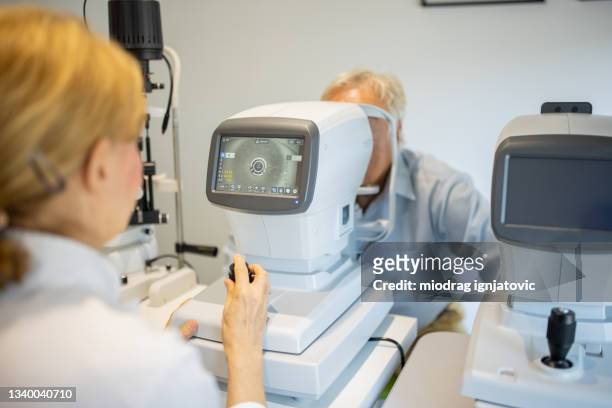 senior man having an eye exam at ophthalmologist's office - cataract eye stock pictures, royalty-free photos & images