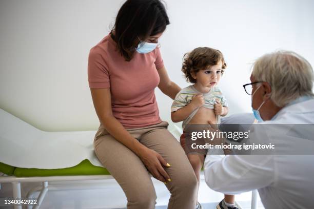 little boy having medical exam at pediatrician office - stomach child stock pictures, royalty-free photos & images