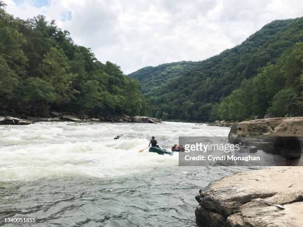white water rafting a surf hole called bloody nose in the rapid miller's folly on the new river gorge - fayetteville stock pictures, royalty-free photos & images