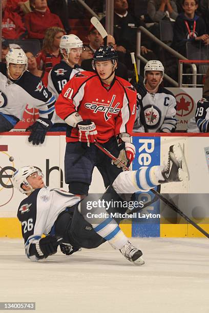 Blake Wheeler of the Winnipeg Jets falls after taking a hit from Dmitry Orlov of the Washington Capitals during a NHL hockey game on November 23,...