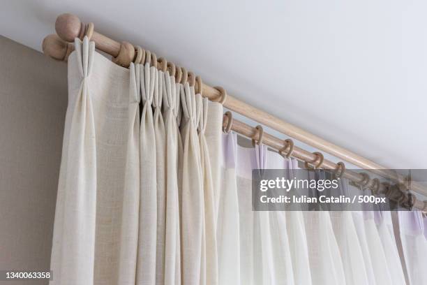 close-up of clothes hanging on rack at home - plisado patrón visual fotografías e imágenes de stock