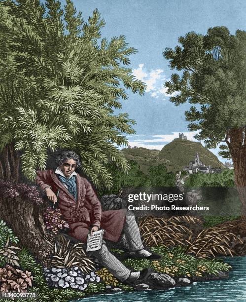 Colorized illustration depicts German composer Ludwig van Beethoven , a pen and sheet of music in his hands, as he sits beside a brook, 1834.