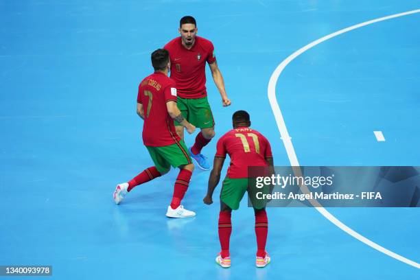 Erick of Portugal celebrates with teammates Bruno Coelho and Pany after scoring their team's second goal during the FIFA Futsal World Cup 2021 group...