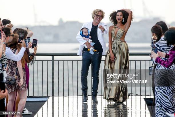 Fashion designer Peter Dundas and Imaan Hammam walks the runway during the Dundas X Revolve Ready to Wear Spring/Summer 2022 fashion show as part of...