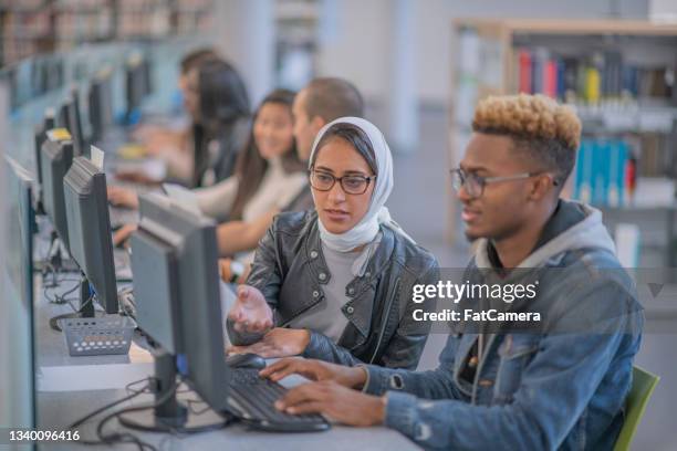 two secondary students in a computer lab - computer lab stock pictures, royalty-free photos & images