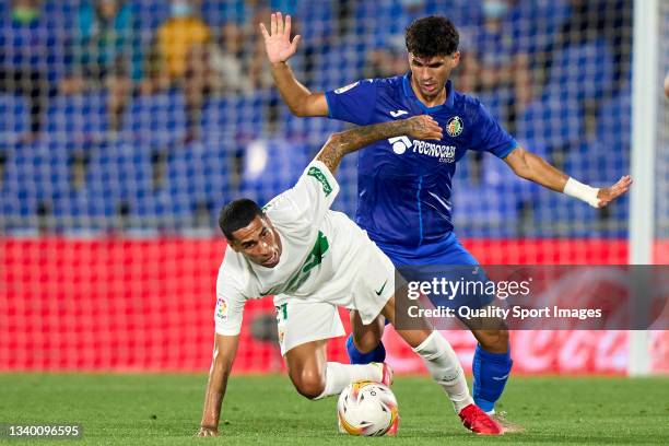 Carles Alena of Getafe CF battle for the ball with Omar Mascarell of Elche CF during the La Liga Santander match between Getafe CF and Elche CF at...