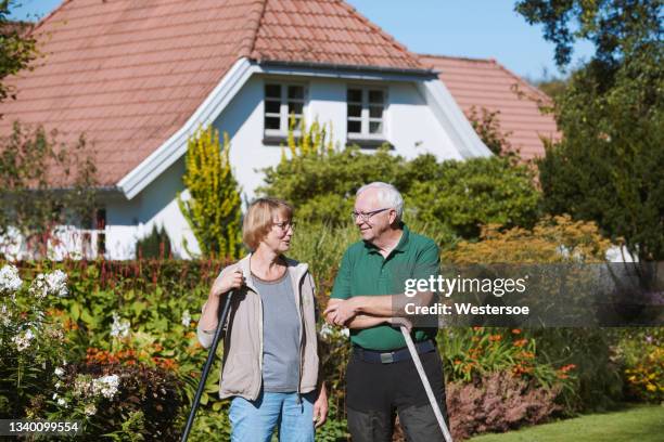 retired couple in front of their home - scandinavian home stock pictures, royalty-free photos & images