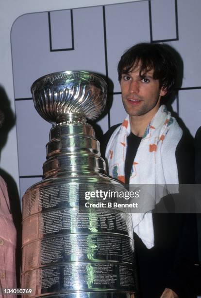 Scott Niedermayer of the New Jersey Devils celebrates in the locker room with the Stanley Cup Trophy after Game 4 of the 1995 Stanley Cup Finals...