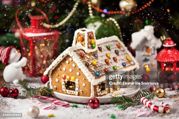 homemade christmas gingerbread house with holiday   decorations, candles, lanterns - glaserad mat bildbanksfoton och bilder