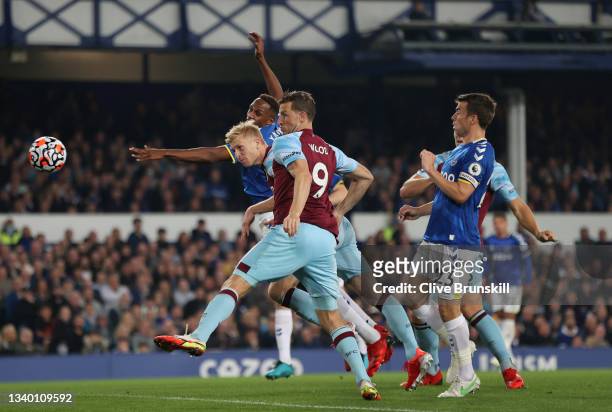 Ben Mee of Burnley scores their team's first goal during the Premier League match between Everton and Burnley at Goodison Park on September 13, 2021...