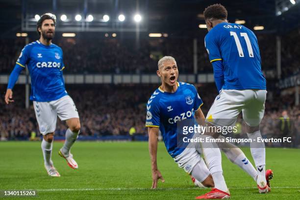 Demarai Gray of Everton celebrates scoring his team's third goal with team mates Richarlison and Andre Gomes during the Premier League match between...