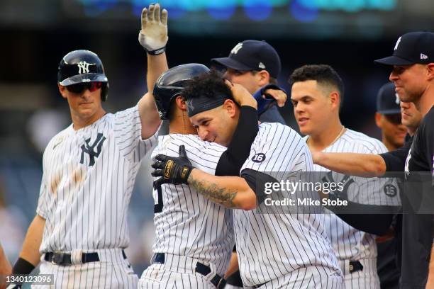 Gary Sanchez of the New York Yankees celebrates after hitting a walk-off single in the bottom of the tenth inning against the Minnesota Twins at...