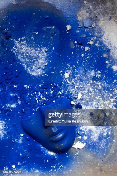 blue colored face mask on the blue painted background. - face masking stock pictures, royalty-free photos & images
