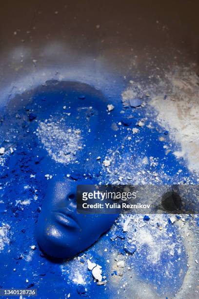 blue colored face mask on the blue painted background. - マスキング効果 ストックフォトと画像