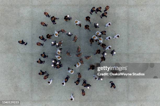 group of people standing on concrete floor - crowd stockfoto's en -beelden